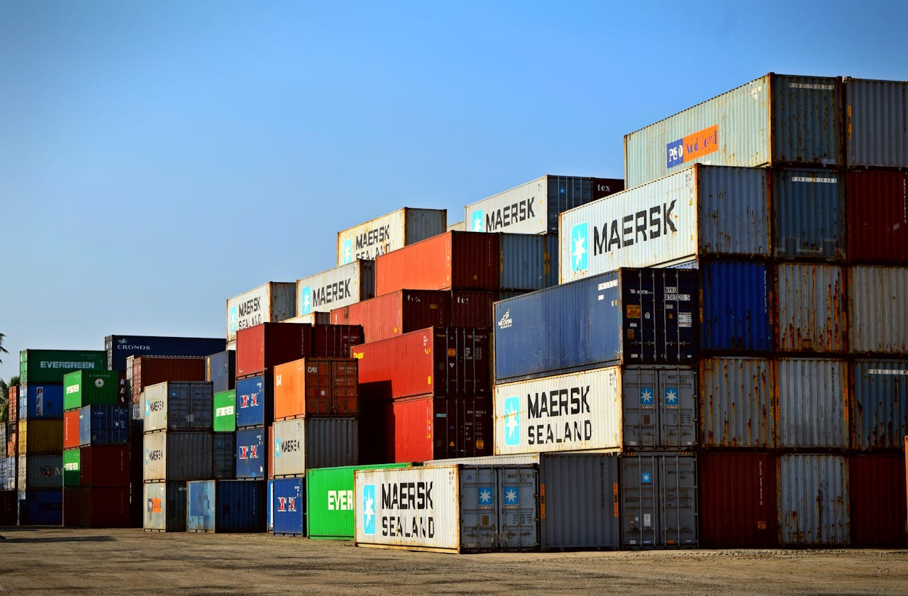 our-experience Colorful stacked shipping containers at a port exemplify global logistics.